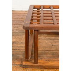 a wooden bench sitting on top of a hard wood floor