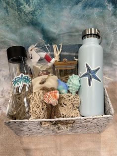 a basket filled with assorted items sitting on top of a beach