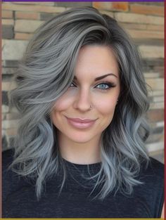 Discover the art of gray blending for dark hair – a low-maintenance, confidence-boosting technique that seamlessly integrates silver strands. Learn about the benefits, care tips, and styling options for this modern approach to embracing your natural gray. Join the movement towards authentic beauty and age positivity with our comprehensive guide to gray blending Blue Eyes Grey Hair, Medium Length Gray Hair With Layers, Grey Hair Green Eyes, Gray Hair Blending Dark Brown, Silver Hair Highlights Going Gray, Black Hair Silver Highlights, Age Positivity, Medium Gray Hair, Grey Hair Colour