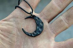 The crescent as a symbol does not need any special descriptions, since it has a multitude of meanings to different people. Each one of these amulets is hand forged and thus every one is unique. Crescent pendants are available as black mild steel versions and metallic brushed stainless steel. Please note that the stainless steel version contains nickel and thus is not recommended for individuals with nickel allergy. Width: 30 mm (~1,2 inches) Height: 30 mm (~1,4 inches) The jewel cords available Unique Black Moon Phase Jewelry, Unique Black Jewelry With Moon Phase, Spiritual Hand-forged Crescent Jewelry, Symbolic Black Hand Cast Jewelry, Symbolic Hand-forged Black Jewelry, Symbolic Hand Forged Black Jewelry, Black Symbolic Jewelry With Moon Charm, Symbolic Black Necklace With Moon Charm, Symbolic Black Crescent Jewelry