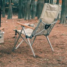 a camping chair sitting in the middle of a forest