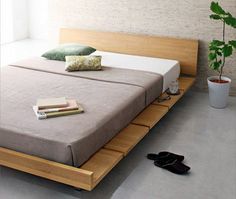 there is a bed that has been made with wooden slats on the bottom and sides