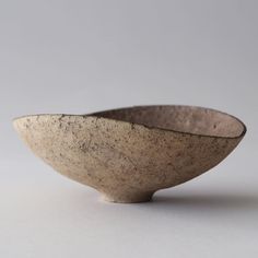 a small bowl sitting on top of a white table