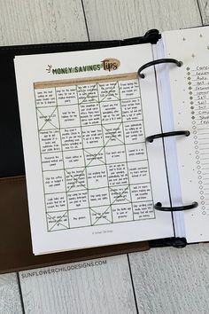 an open planner with the words money saving on it