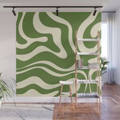 a green and white wall mural with wavy lines in the center, on a wooden floor