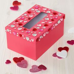 a pink box with hearts scattered around it