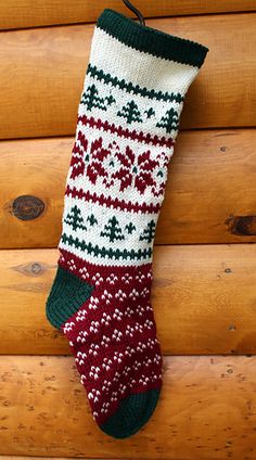 a christmas stocking hanging on the side of a wooden wall