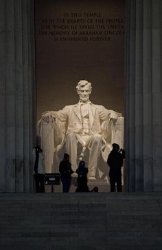 the lincoln memorial with people standing around it