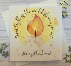 a christmas card with an elephant holding a lit candle