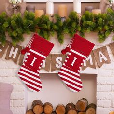 christmas stockings hanging on the fireplace with candles