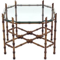 a round glass table with bamboo sticks on the top and bottom, against a white background