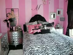 a zebra print bed in a pink and black bedroom