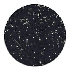 a black plate with white stars and the zodiac sign on it's side, in front of a white background