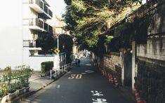 an empty street is lined with buildings and trees