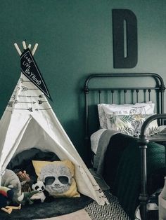 a child's bedroom with a teepee tent and stuffed animals