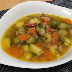 a white bowl filled with soup on top of a table