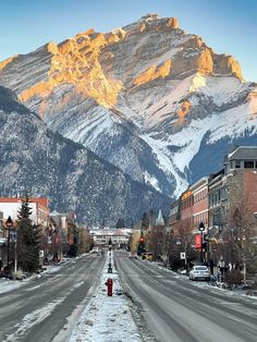 the mountains are covered in snow and buildings