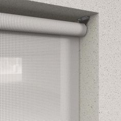 a close up view of a window with a mesh curtain on it's side