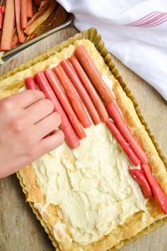 a person cutting up carrots on top of a pie crust in preparation for baking