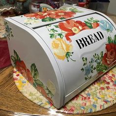 a decorated bread box sitting on top of a table