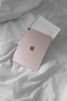 an apple ipad in its box on a bed