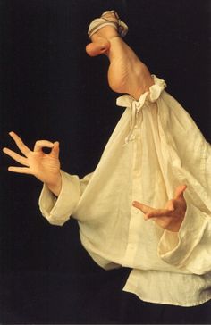 an image of a puppet that appears to be holding out their hands for the camera