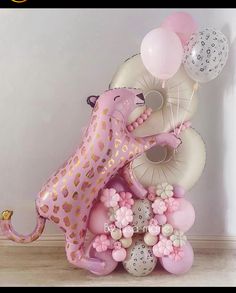 some balloons are in the shape of animals and giraffes on top of each other