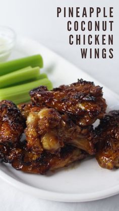 some chicken wings are on a plate with celery