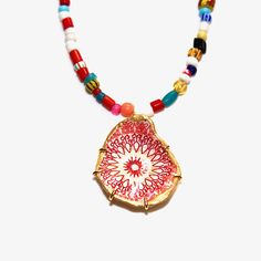 "This fun upcycled red medallion oyster shell necklace uses shells collected from the beaches of Wellfleet, Massachussets. They are decoupaged with fun, colorful papers. The backs and edges are painted with gold leaf paint and set in a gold vermeil prong setting with a Christmas Trade Bead necklace. The necklaces are not water resistant. This necklace measures 16-18\" without the shell drop. All shells come boxed and ready for gift giving. ❤️ Listing is for one shell . 🐚 Please Note: Oyster and Handmade Red Shell Necklace Gift, Handmade Red Shell Necklace For Gift, Handmade Red Beaded Necklaces With Round Pendant, Handmade Red Beaded Necklace With Round Pendant, Red Bohemian Shell Necklace For Gift, Artisan Coral Necklace For Gift, Artisan Red Necklace With Round Pendant, Bohemian Shell-shaped Beaded Necklace Gift, Red Amulet Beaded Necklaces With Colorful Beads