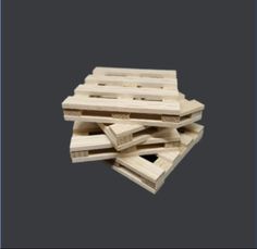 wooden pallets stacked on top of each other in the middle of a gray background