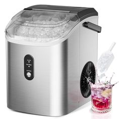 the ice maker is next to a glass filled with water and ice on a white background