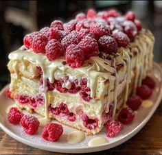 a piece of cake with raspberries on top