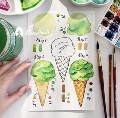 someone is painting ice cream on paper with watercolors and crayon pens