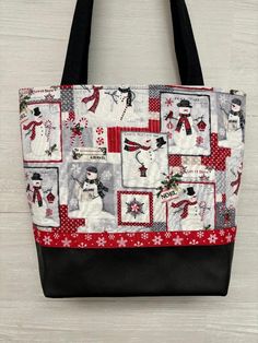 a red and white tote bag with snowman images on it's side