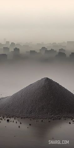 Pile of sand on top of a beach next to a city skyline in the foggy sky. Color RGB 166,186,183. PANTONE, PANTONE 5507. Beautiful landscapes and cityscapes.Follow us and visit our site for more amazing content! #design #Pile #next #sand #PANTONE5507 #beach #travelling #sketchbook #graphic #unique #cityscapes #travelblogger #landscape #city #artwork