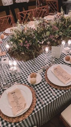 the table is set with plates and place settings