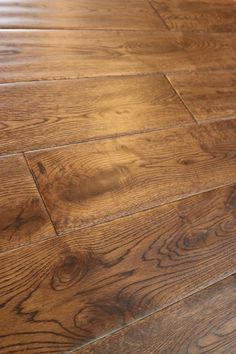 a close up view of the wood flooring in a room with hard wood floors