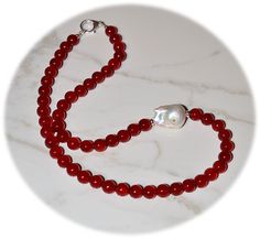 "D E T A I L S (ready to ship) △ Handmade in Canada △ Gemstone Type:      Vibrant Red Jade beads (color-enhanced) △ Gemstone Size:       8.0 mm △ Gemstone Shape:   Round △ Pearl Type:                Natural Baroque Freshwater Pearl High Luster (inlaid with melee diamond) △ Pearl Size:                 23.4x17mm △ Pearl Quality:            AAA △ Pearl Body Color:    White △ Pearl Shape:             Tear Drop △ Necklace Length:     19.5\" including clasp △ Sterling Silver accents & large teardrop lobster claw clasp Special Note:  All red jade beads on the market are color-enhanced. Additional policies:  All pieces in my studio are created by my hand, so NO TWO ITEMS ARE IDENTICAL. I take great care to produce each piece as a unique work of art.  Please allow for some artistic variation from w Red Jade, Teardrop Necklace, Jade Jewelry, Pearl Types, Body Color, Jade Beads, Drop Necklace, Silver Accents, Pearl Size