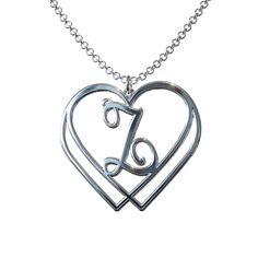 Hearts entwined initial heart pendant This beautiful pendant is a symbol of unbreakable love and devotion. Wear it close to your heart to always remind you of your special connection. The perfect personalized touch for any outfit. Available in Sterling Silver or 14kt Gold or Rose Gold Plated Sterling Silver, stamped .925 Rolo Chain, soldered with a Lobster Claw Clasp Chain available in 18 inch length Dimensions: H 1 1/8 Inch Gift Box, Special Care Instructions and Cloth Storage Pouch included Made in USA Hearts Entwined, Cloth Storage, Initial Pendant, Rolo Chain, Storage Pouch, 14kt Gold, Name Plate, Gold Plated Sterling Silver, Lobster Claw