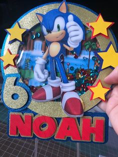 someone is holding up a card with sonic the hedgehog on it and stars around it