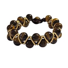 Details:- 10mm Tigers Eye- Size: 7.75"- Gold accents- Macramé toggle closure- Genuine natural stones MATERIAL: Sturdy black adjustable cord. For long-lasting wear for years to come, we suggest not to wear this in the ocean, shower, or in the pool due to the harsh chemicals. Tigers Eye is an incredible healing stone and can be used in many ways to; align certain chakras, balance the body, sharpen the mind, and help you unpack and put away any emotional baggage you have been dragging around with y Casual Jewelry With Adjustable Cord And Round Beads, Adjustable Spiritual Hand Wrapped Jewelry, Adjustable Wire Wrapped Beaded Bracelets For Beach, Adjustable Wire Wrapped Brown Jewelry, Casual Adjustable Braided Bracelets With Natural Stones, Casual Braided Bracelets With Natural Stones, Adjustable Wire Wrapped Bracelets, Adjustable Hand-wrapped Braided Bracelet With Round Beads, Adjustable Round Jewelry With Sliding Knot