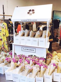 the flowerbox stand is full of flowers for sale