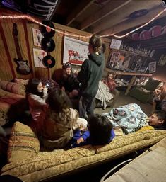 a group of people sitting on top of a bed in a room filled with furniture