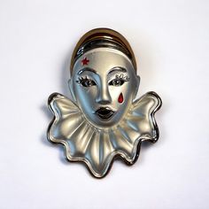 "Vintage matte and shiny silver tone Pierrot brooch with a red star above one eye and a red tear under the other. Closes with a locking rollover 'C' clasp. New old stock. Measurements: 2 1/2\" x 1 3/4\"" Vintage Silver Pins For Party, Vintage Pierrot, Silver Novelty Pins For Gifts, Silver Party Enamel Pin, Silver Novelty Brooches For Gifts, 1950s Brooch, Handmade Silver Victorian Brooch, Vintage Silver Enamel Pins, Silver Retro Brooches For Gift