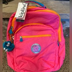 Questions? Leave A Comment Below! This Kipling Backpack Is Perfect For Those Who Are Always On-The-Go! With A Spacious Interior, Adjustable Straps, And Pockets, This Backpack Is Great For School, Travel, Or Casual Outings. The Exterior Is A Flashy Pink Chain Color With A Cute Monkey Character Tag And A Key Chain Accessory. The Bag Has An Oval Shape And Features A Zip Closure, Silver Hardware, And A Combination Of Polyester, Nylon, And Canvas Materials For The Handle/Strap. This Limited Edition S Pink Standard Backpack, Pink Backpack For Everyday Use And Back To School, Pink Backpack For Everyday Use, Monkey Character, Kipling Backpack, Pink Chain, Kipling Bags, Girly Bags, Cute Monkey