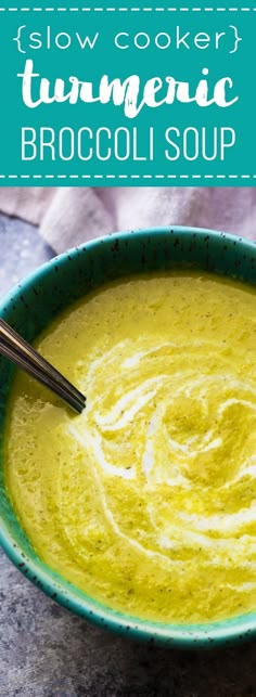 a green bowl filled with broccoli soup on top of a marble countertop