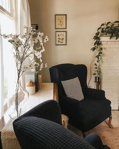 a living room filled with furniture and a fire place in front of a large window