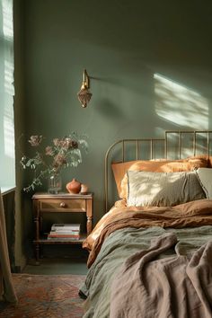 a bed sitting in a bedroom next to a window with sunlight coming through the windows