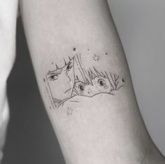 a woman's arm with two faces on it and stars above her head, in black ink