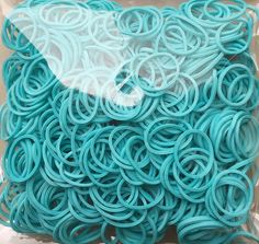 a bag filled with blue rubber bands sitting on top of a table